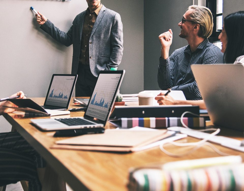 Two professionals engaged in a discussion in a modern office meeting.